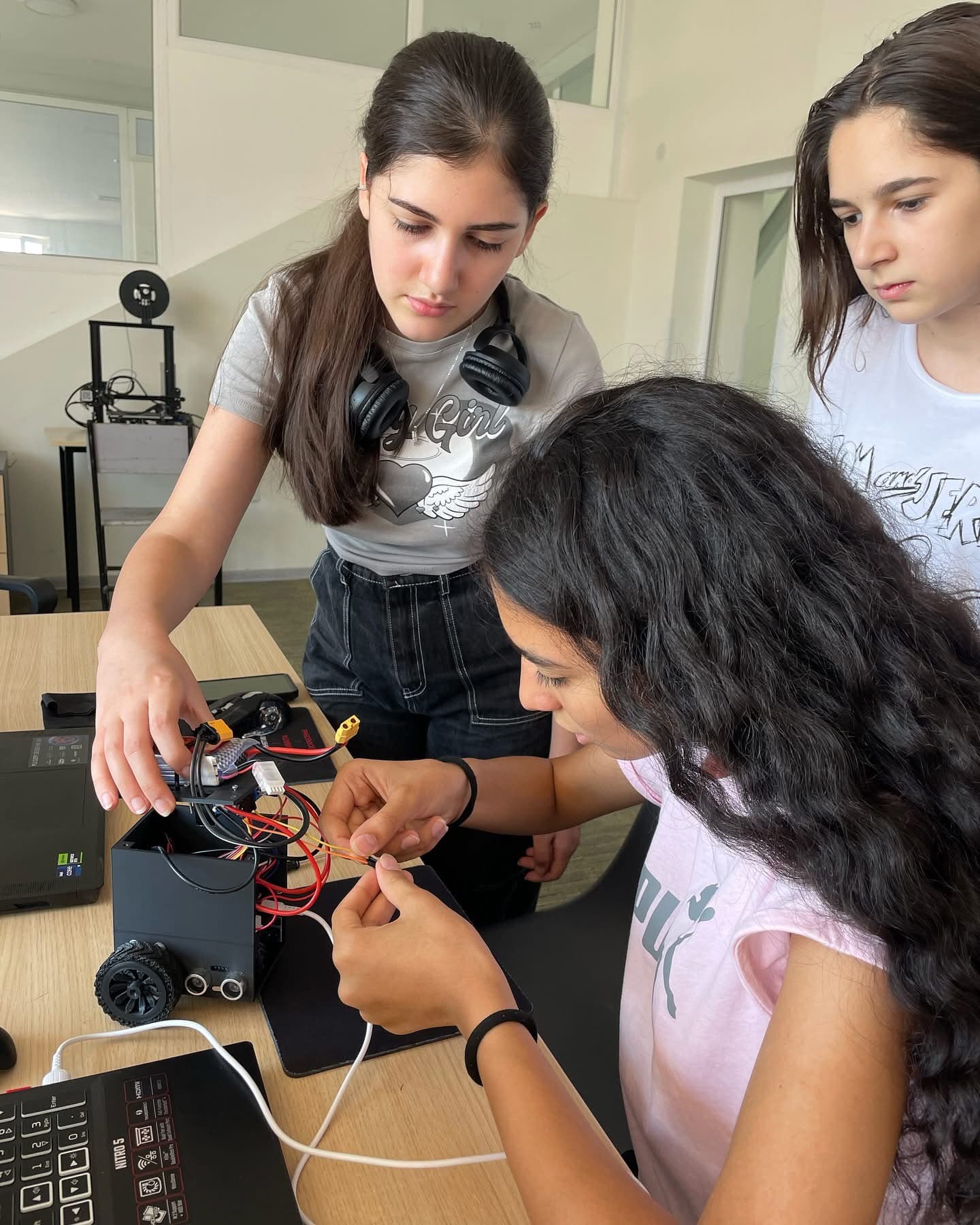 Students building and wiring a robot